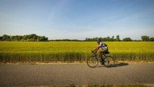 a man riding in a bicycle